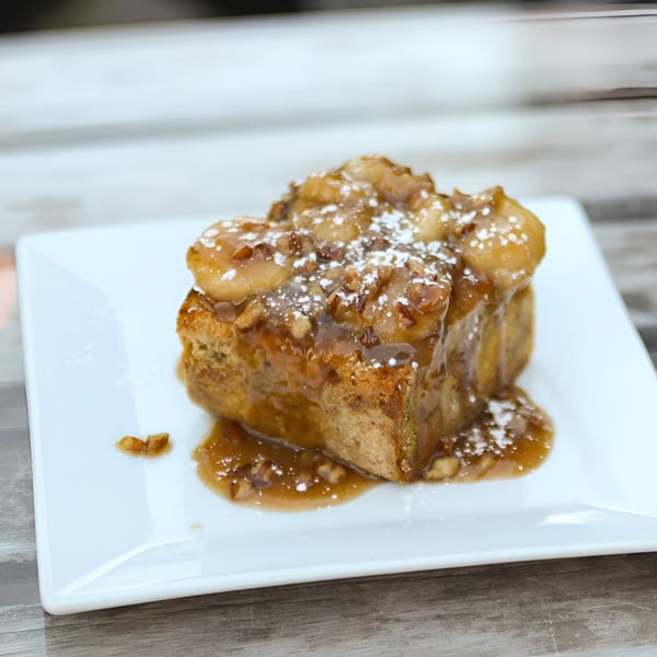 Krewe of McGinley Square's cajun bread pudding with bananas, pecans, caramel sauce, and powdered sugar.