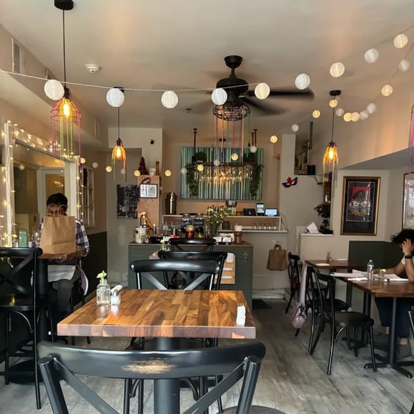 Interior of Krewe of McGinley Square, a Cajun restaurant, with tables, chairs, and festive lighting.
